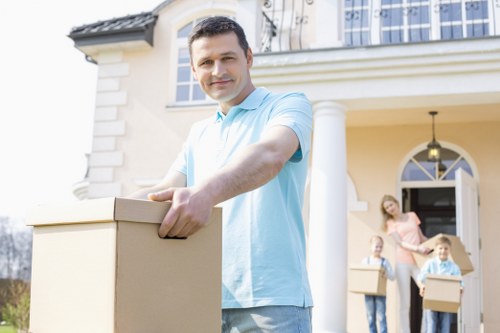 Professional movers handling office equipment